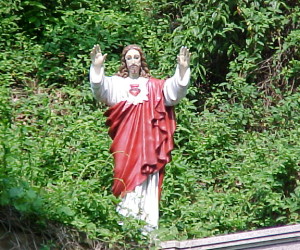 Statue of Jesus stands watch outside of the chapel