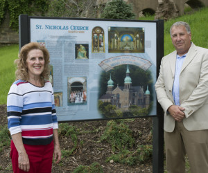 Susan Petrick and Steve Willing admire the St. Nicholas Church Interpretive Panel.