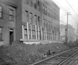 1920 - View of men raising 23in. cast iron line at 721 E. Ohio St. 715.205058.CP **